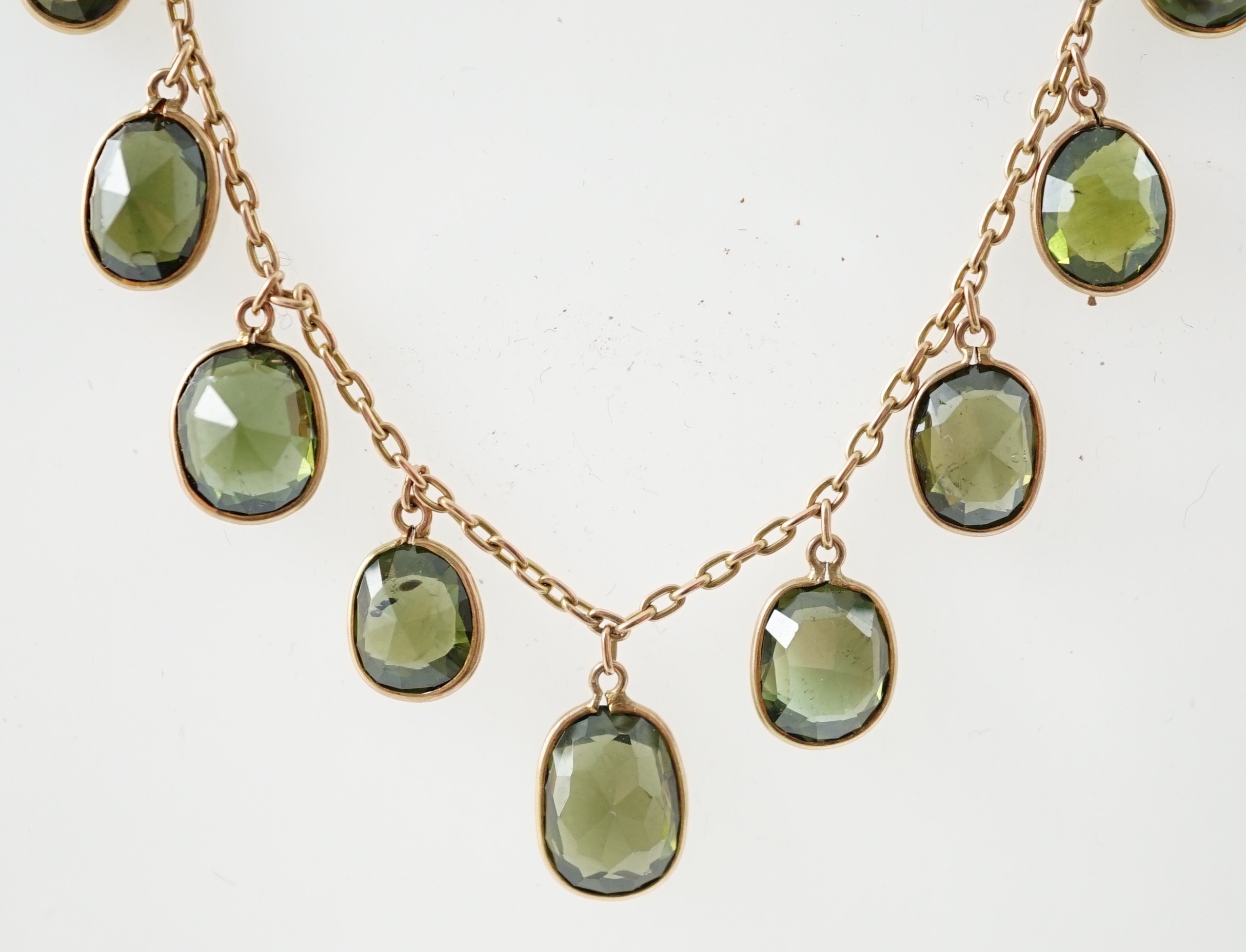 A late Victorian 15ct gold and graduated oval cut green tourmaline fringe choker necklace